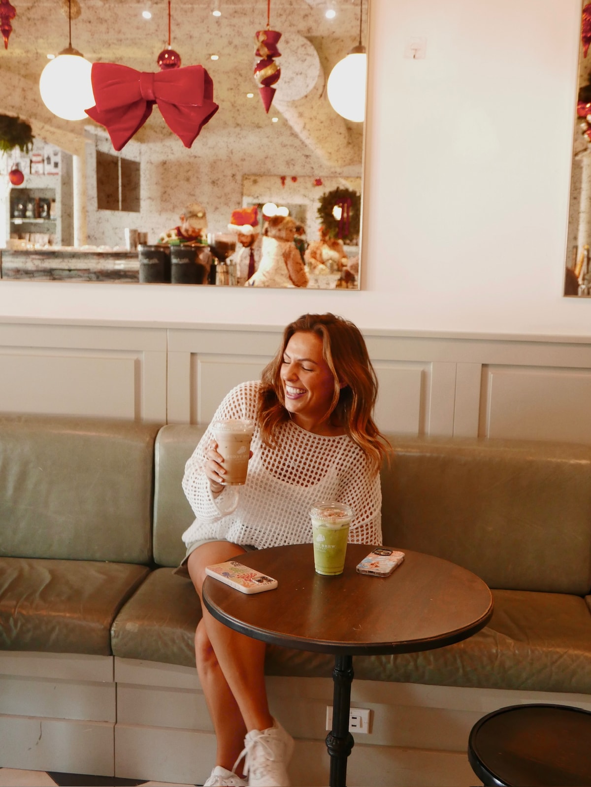 Isabella laughing over coffee at a cafe