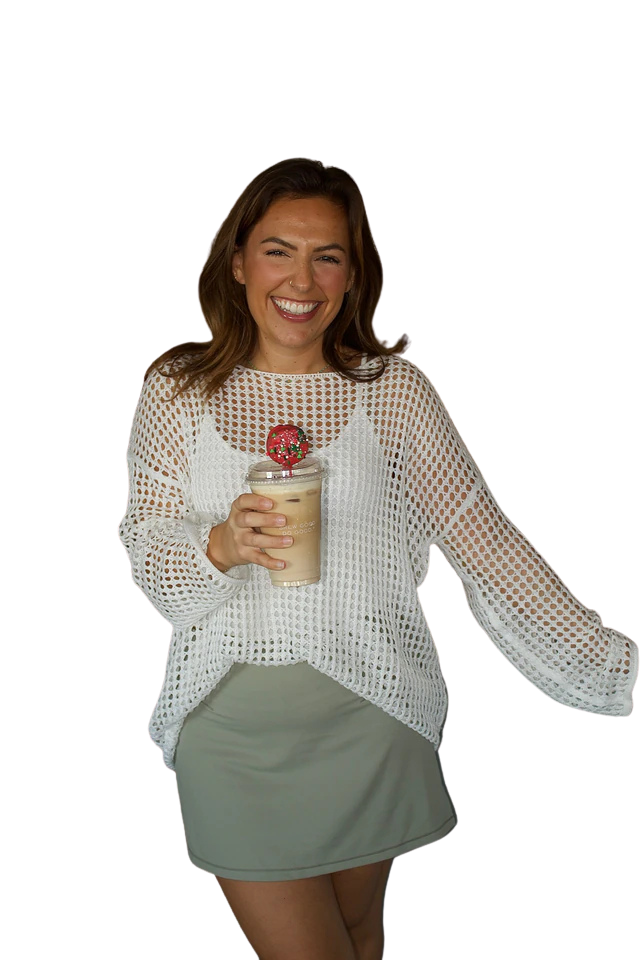 Isabella smiling while holding an iced coffee